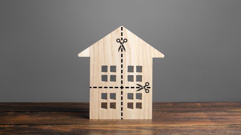 wooden model of a house divided into parts by dotted lines