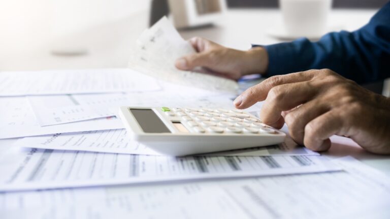 men is using calculator to calculate expenses and tax