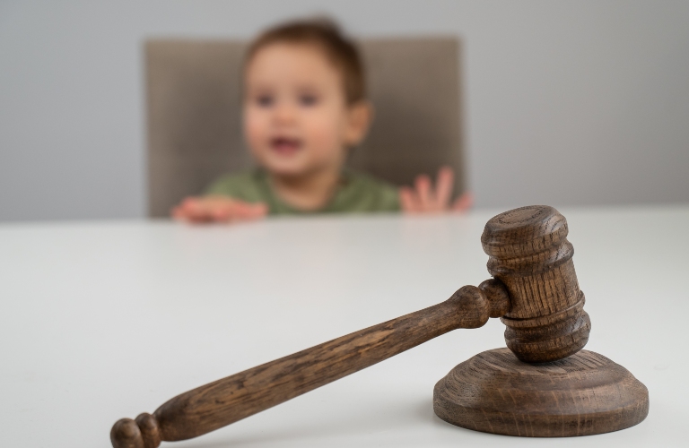Little boy behind judge's gavel